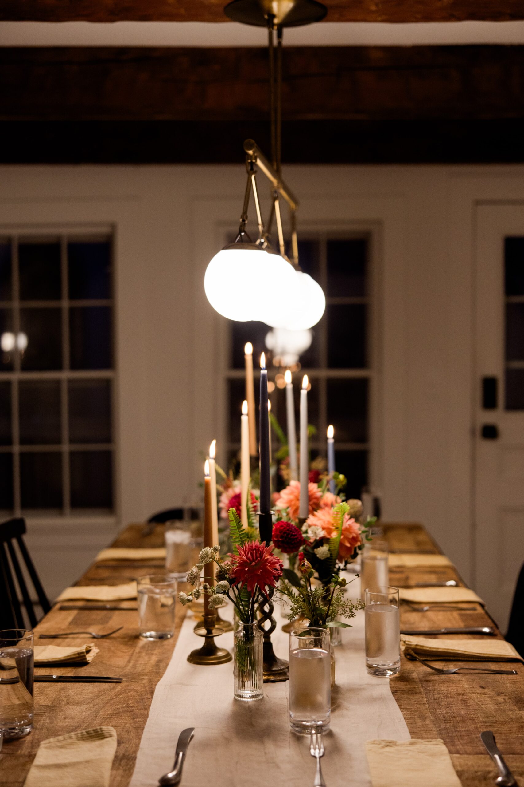 Candlelit table set for an elopement dinner at an Airbnb cabin. 