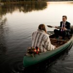 Bride and Groom take a canoe ride at sunset on their elopement day.