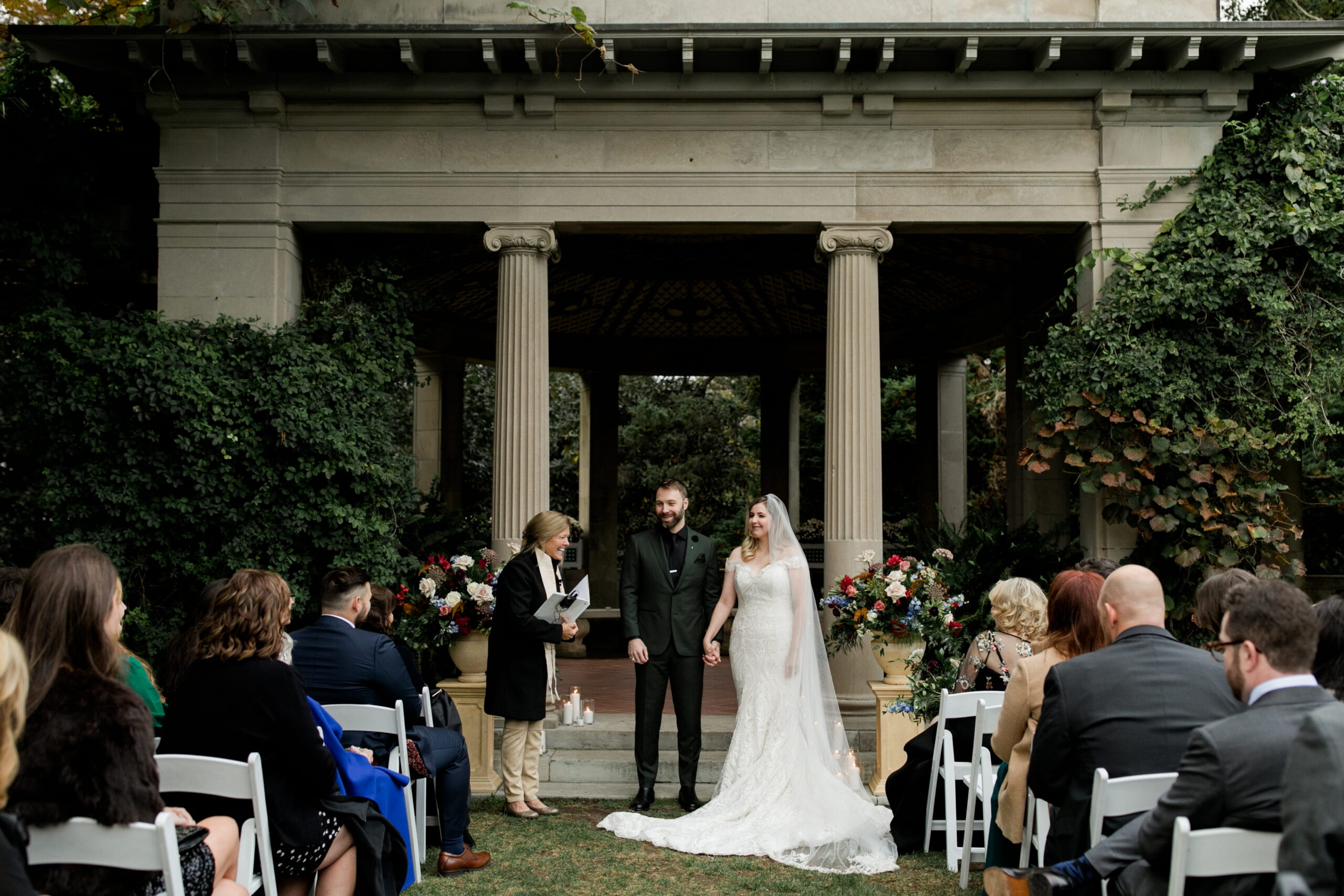 Wedding officiant laughs while leading a couple through their ceremony at Eolia Mansion. 